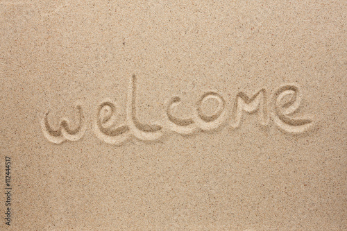 Welcome is the inscription by hand on the sand