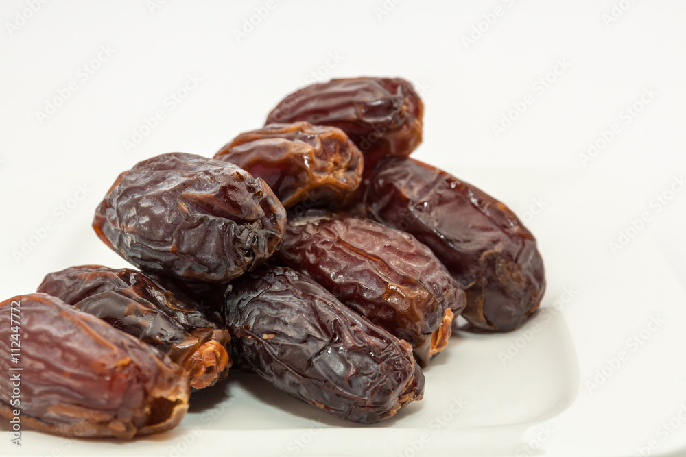 Date fruits in white plate - Ramadan, Eid background Date fruits in white plate - Ramadan, Eid background