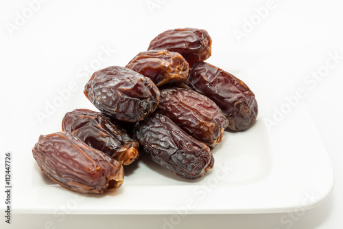 Date fruits in white plate - Ramadan, Eid background