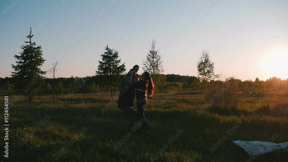 Happy family playing with a baby in nature Happy family playing with a baby in nature