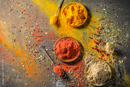 Fototapeta Naklejka Na Ścianę i Meble -  Mess with vivid spices on old board