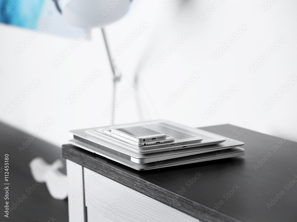 Pile of electronic gadgets on the table. Communication and technology concept Pile of electronic gadgets on the table. Communication and technology concept