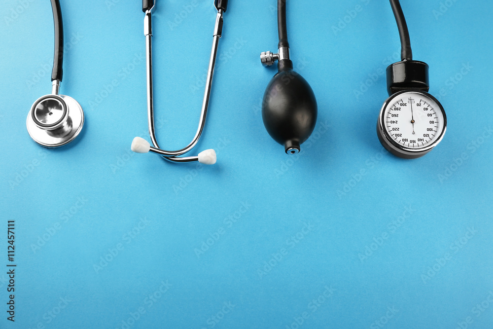 Medical manometer and a stethoscope on blue background Medical manometer and a stethoscope on blue background