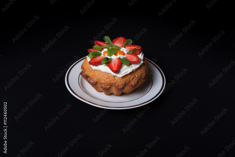 Fresh cake with cream and berries on black background Fresh cake with cream and berries on black background