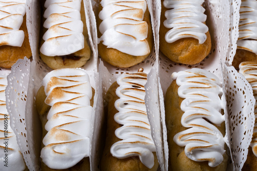 Fresh homemade eclairs white cream and chocolate filling on a da photo