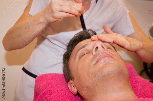Man getting face and head massage in the spa centre