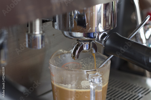 makes coffee using coffee machine.
