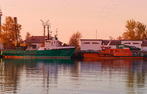 Ships in the Marina in Ventspils at sunset photo