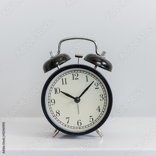 modern black alarm clock on white