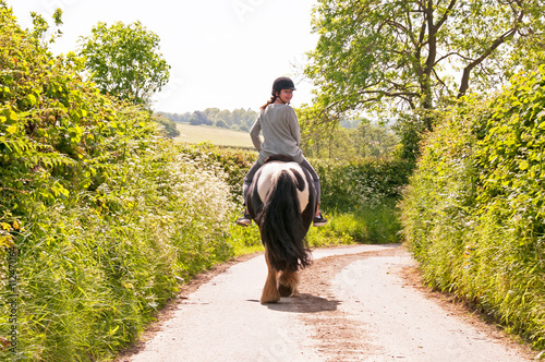 Young girl riding down the Shropshire lanes while looking behind her © chelle129