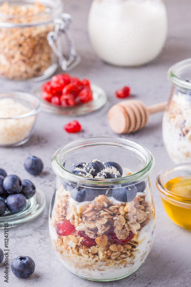 Healthy breakfast - glass jars of oat flakes with fresh fruit.