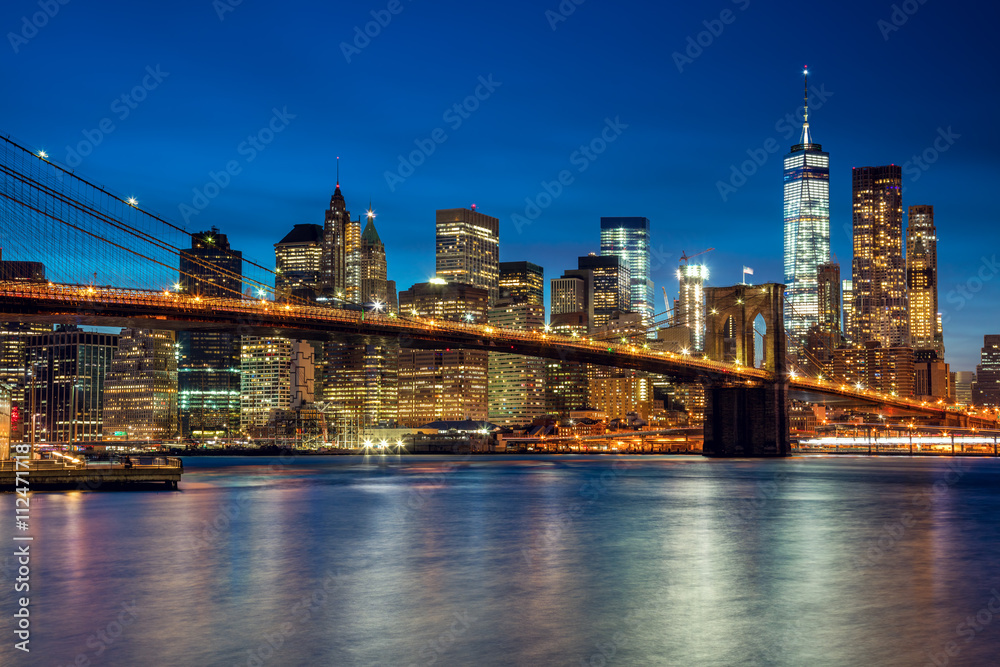Manhattan with skyscrapers and Brooklin Bridge by evening, New