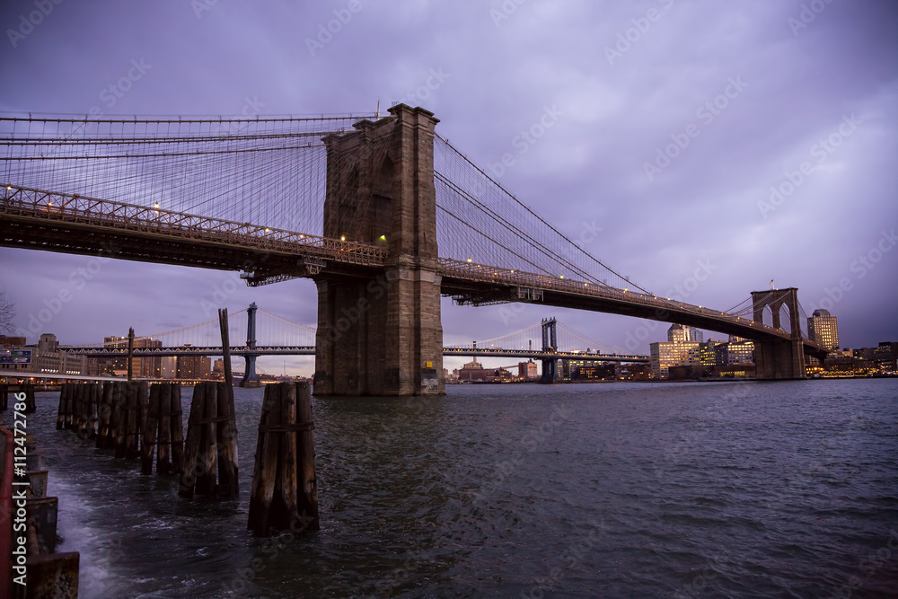 The Brooklyn Bridge in New York City from Seaport at sunrise.