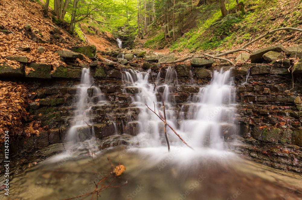 Obraz premium Waterfall on Mosorny creek, Beskid Zywiecki mountain range in Polish Carpathian Mountains