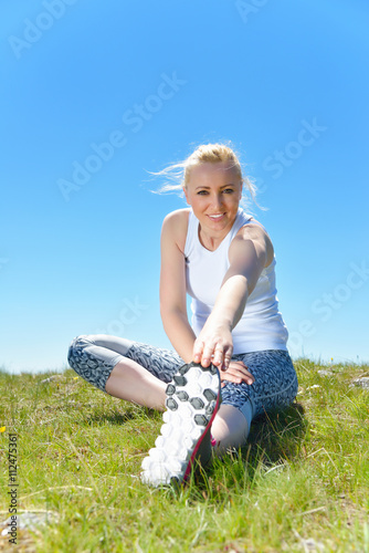 Young sports woman enjoys fitness and bright sunshine