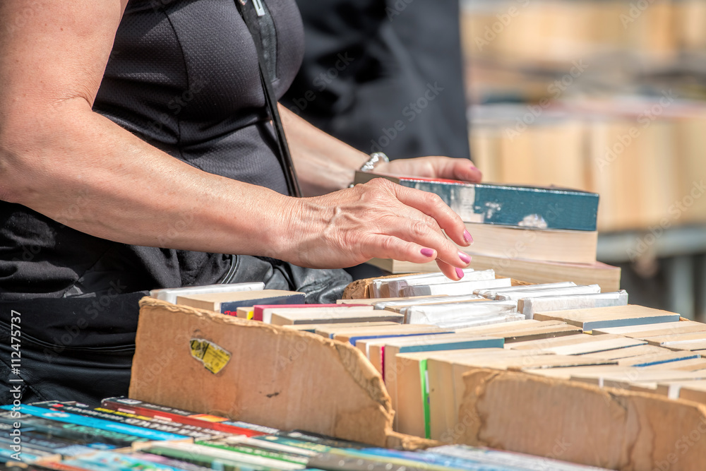 Obraz premium Second Hand Book Stall. Woman Buying Books