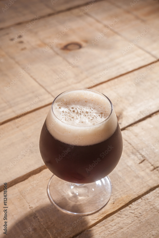 Dark beer on wood Dark beer on wood