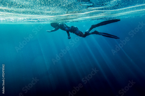 Freediver swim in the sea photo