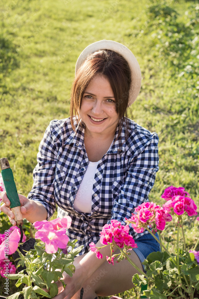 pretty young woman planting flowers pretty young woman planting flowers
