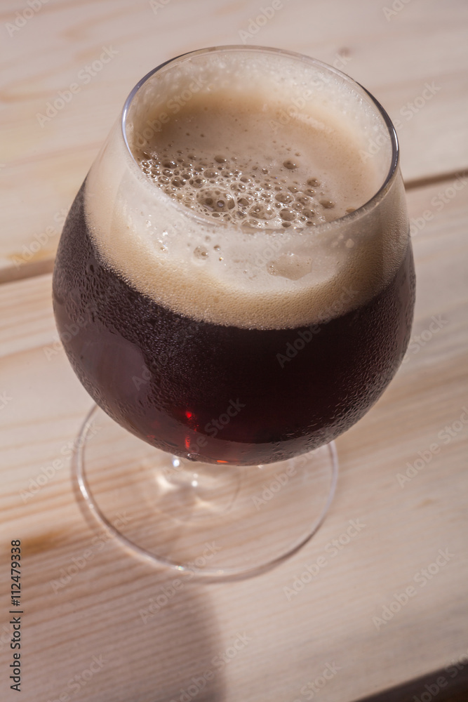 Dark beer on wood table Dark beer on wood table