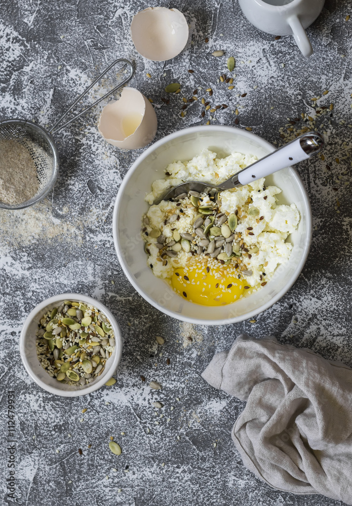 Ingredients for cooking whole grain multi seed bread - whole wheat flour, eggs, ricotta cheese, seeds, on a grey stone background. Baking background Ingredients for cooking whole grain multi seed bread - whole wheat flour, eggs, ricotta cheese, seeds, on a grey stone background. Baking background