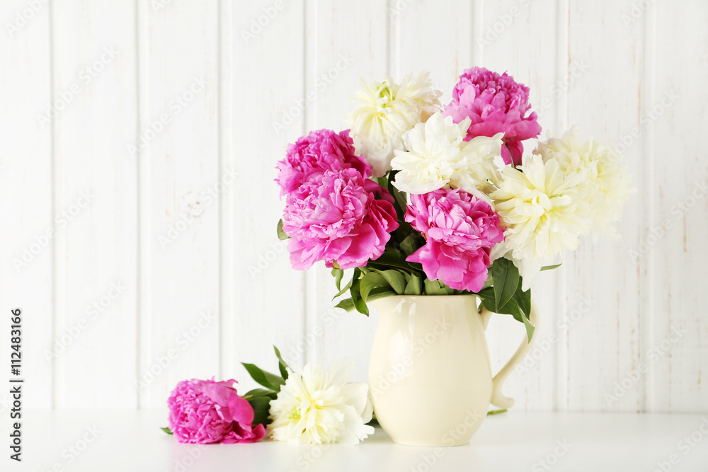 Bouquet of pink and white peony flowers on wal panelling backgro Bouquet of pink and white peony flowers on wal panelling backgro