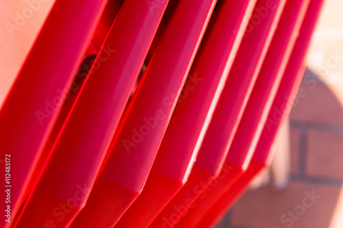 details of stack red chairs from hard plasti photo