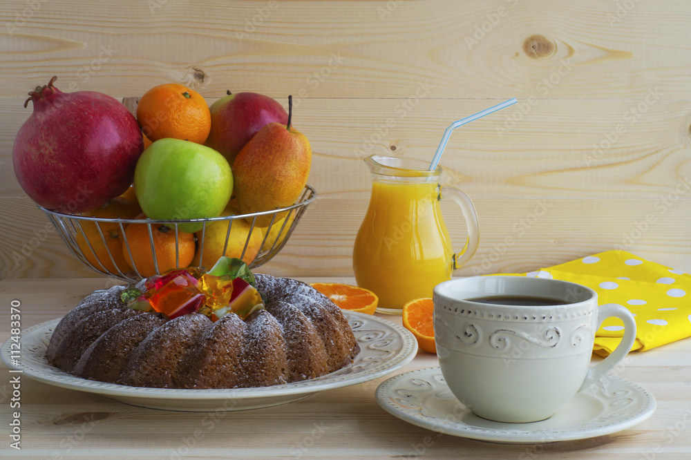 Breakfast concept. Ring Cake with jelly, coffee, exotic fresh fruit and orange juice on a wooden background. Breakfast concept. Ring Cake with jelly, coffee, exotic fresh fruit and orange juice on a wooden background.