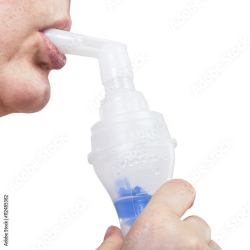 mouthpiece of jet nebulizer in lips of woman
