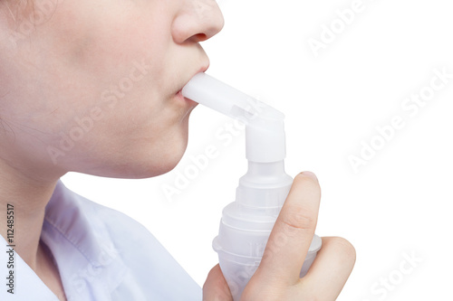 teen inhales with mouthpiece of jet nebulizer