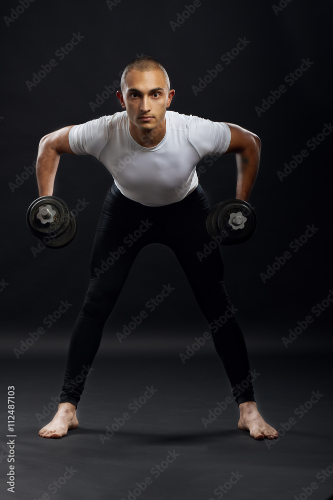Sportsman doing training with dumbbells. Sportsman doing training with dumbbells.