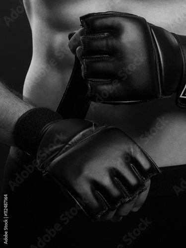 Fighter putting gloves. © serbbgd
