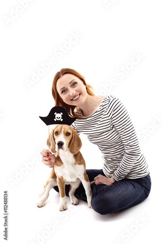 Cheerful girl is playing with her dog