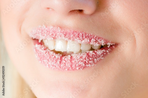 closeup on young pretty woman with beautiful lips in sugar