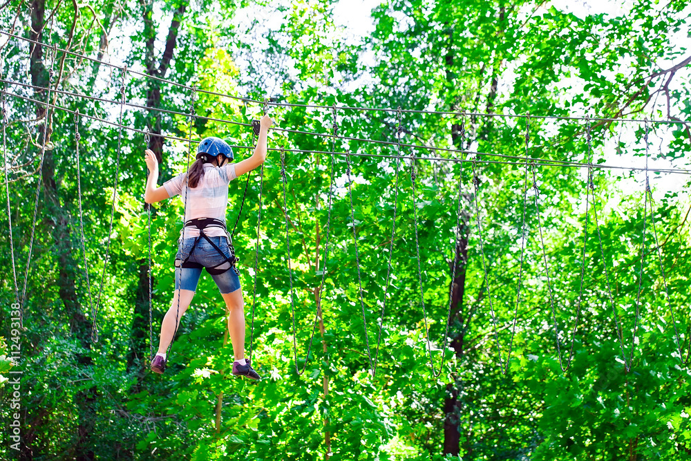 adventure climbing high wire park - people on course in mountain adventure climbing high wire park - people on course in mountain