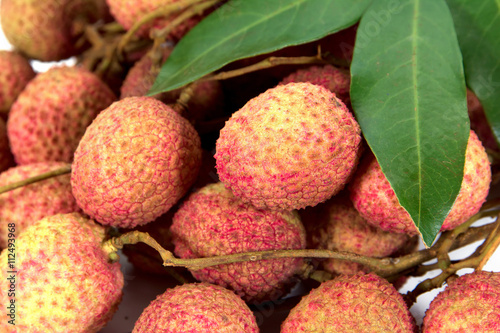 Closeup of lychees with leaves background texture