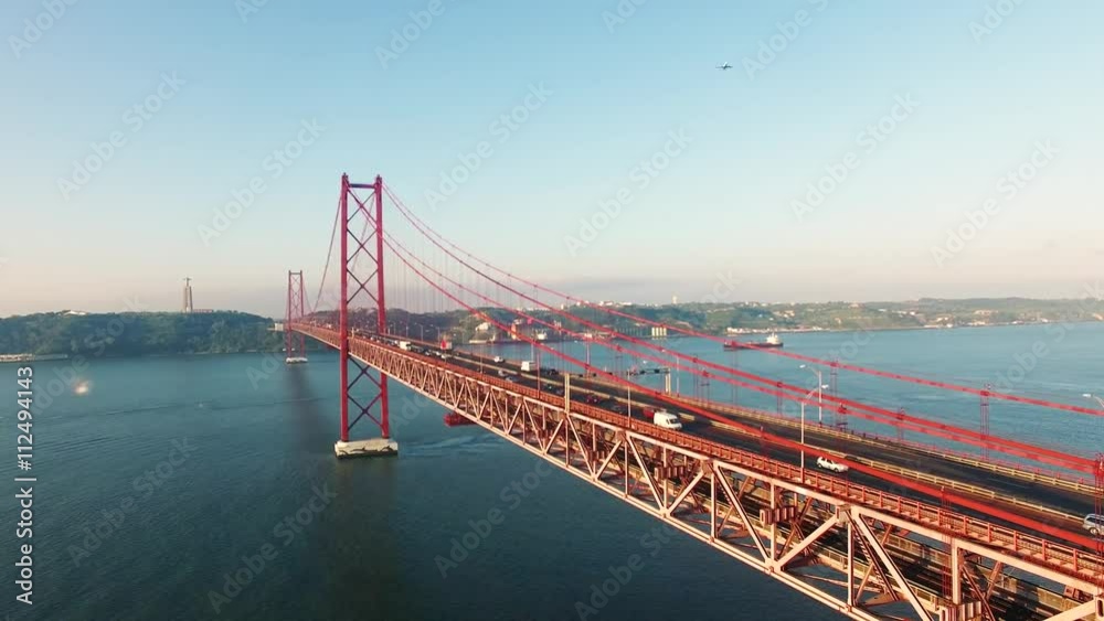 Cars on Bridge Ponte 25 de Abril over the Tagus river in Lisbon, Portugal at morning aerial view