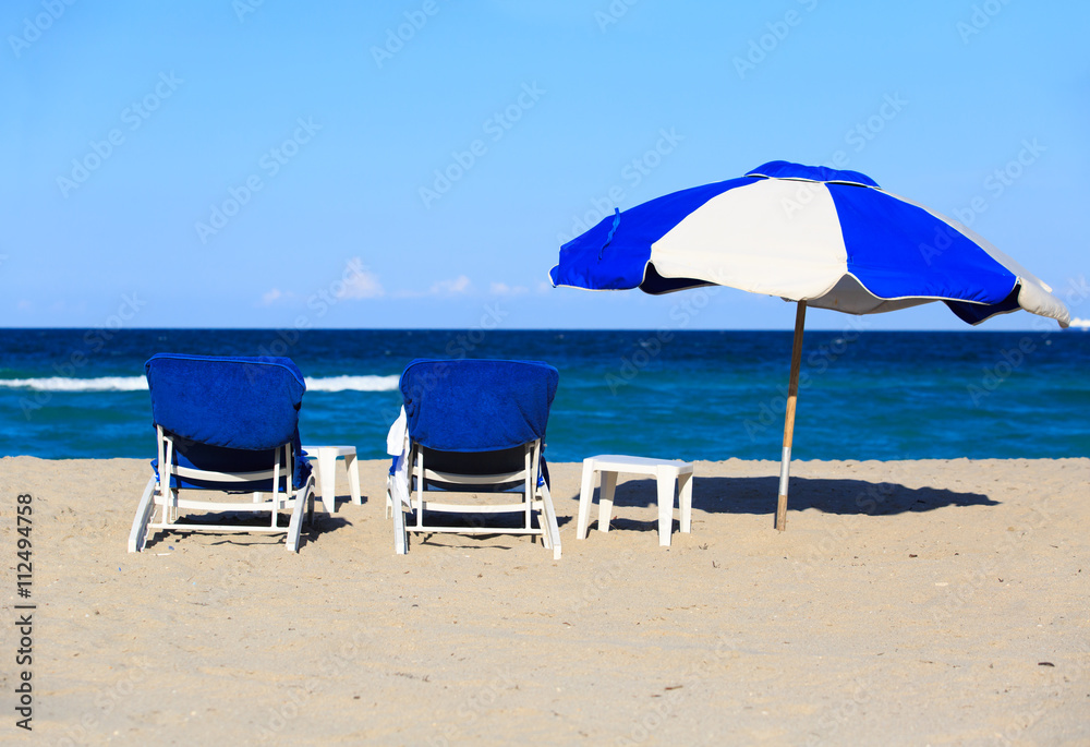 Two chairs on sand beach