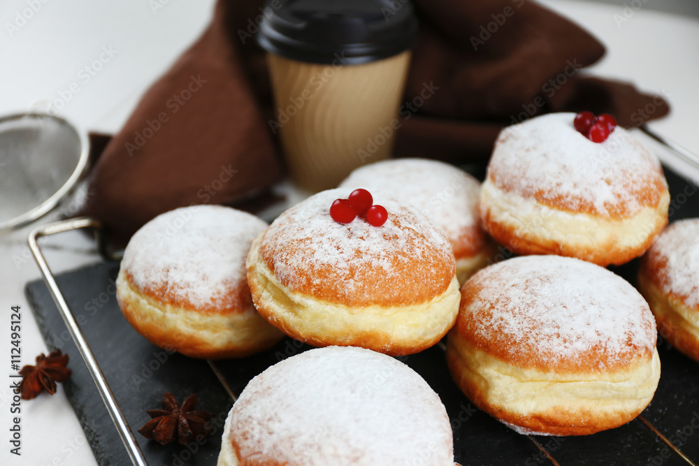 Fresh homemade donuts with powdered sugar, close up