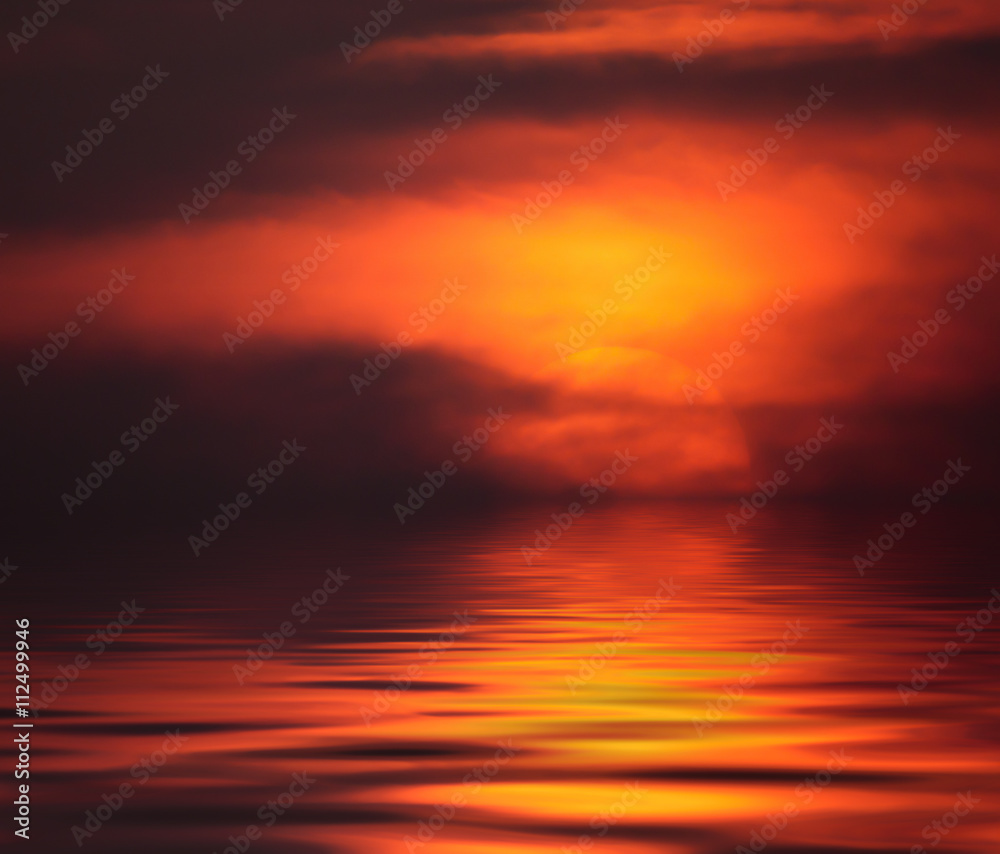 Fiery sunset with reflection in water