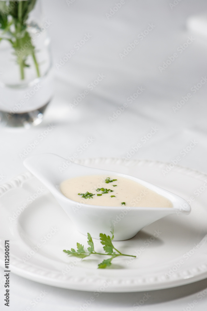 Tasty Bechamel sauce or white sauce with fresh greenery Tasty Bechamel sauce or white sauce with fresh greenery