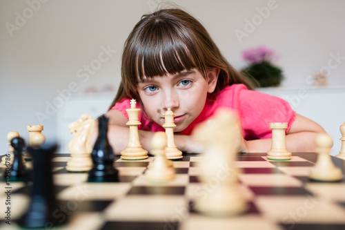 Girl and chess pieces photo