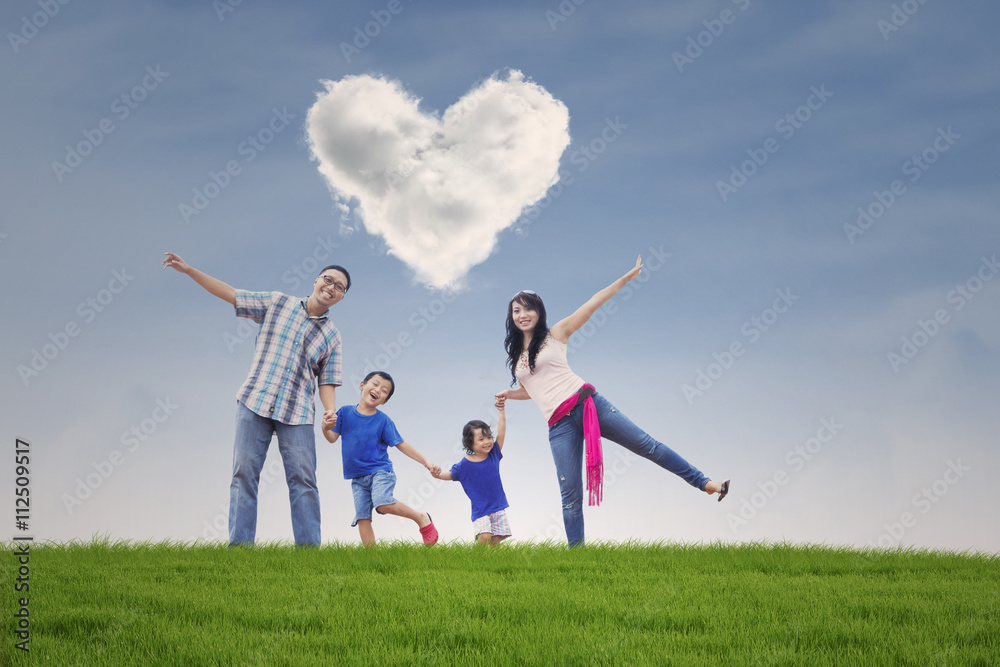 Happy family at field with heart symbol Happy family at field with heart symbol