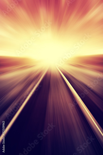 Railway in motion blur at sunset. Vintage image.