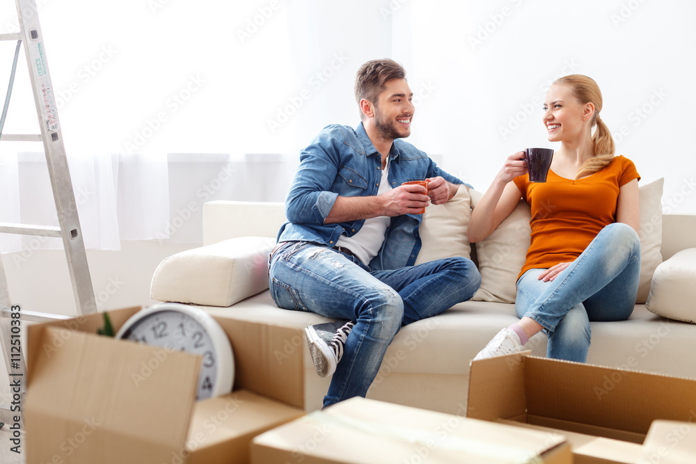 Young couple drinking coffee on sofa Young couple drinking coffee on sofa