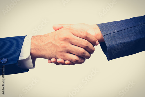 Handshake of businessman and businesswoman, vintage tone