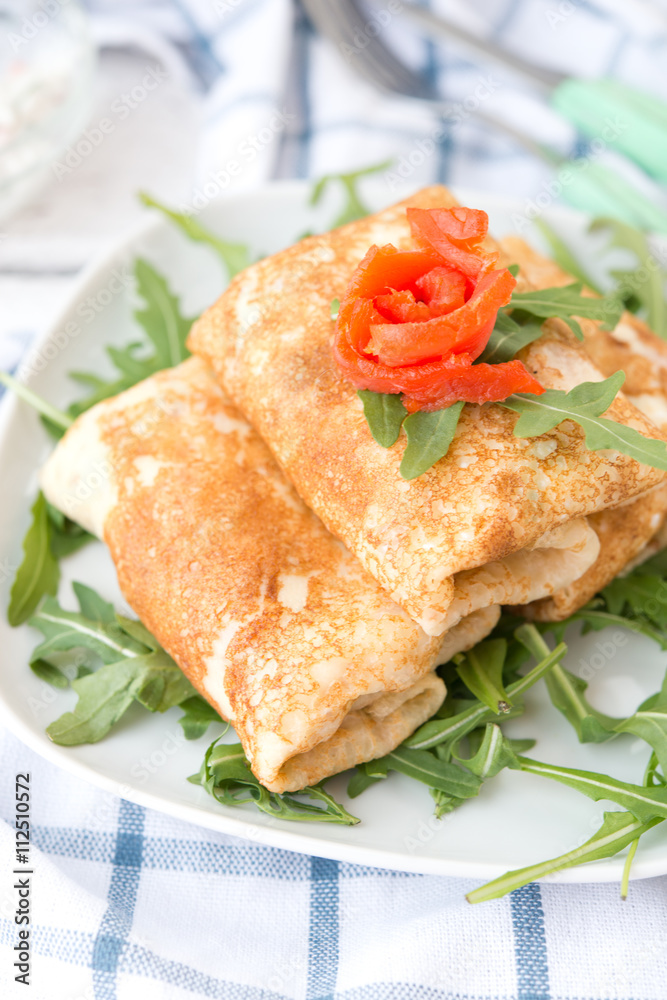 Nourishing pancakes with red fish and cream cheese
