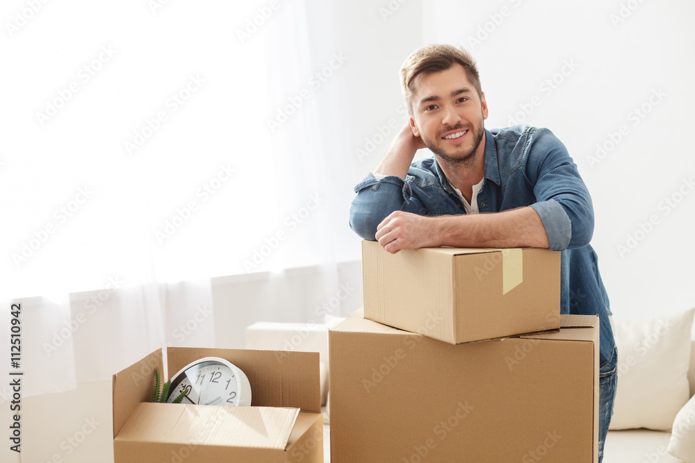 Smiling guy moving into his new home