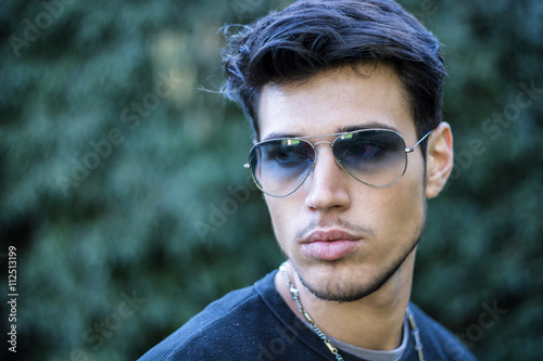Attractive young man's headshot in urban setting
