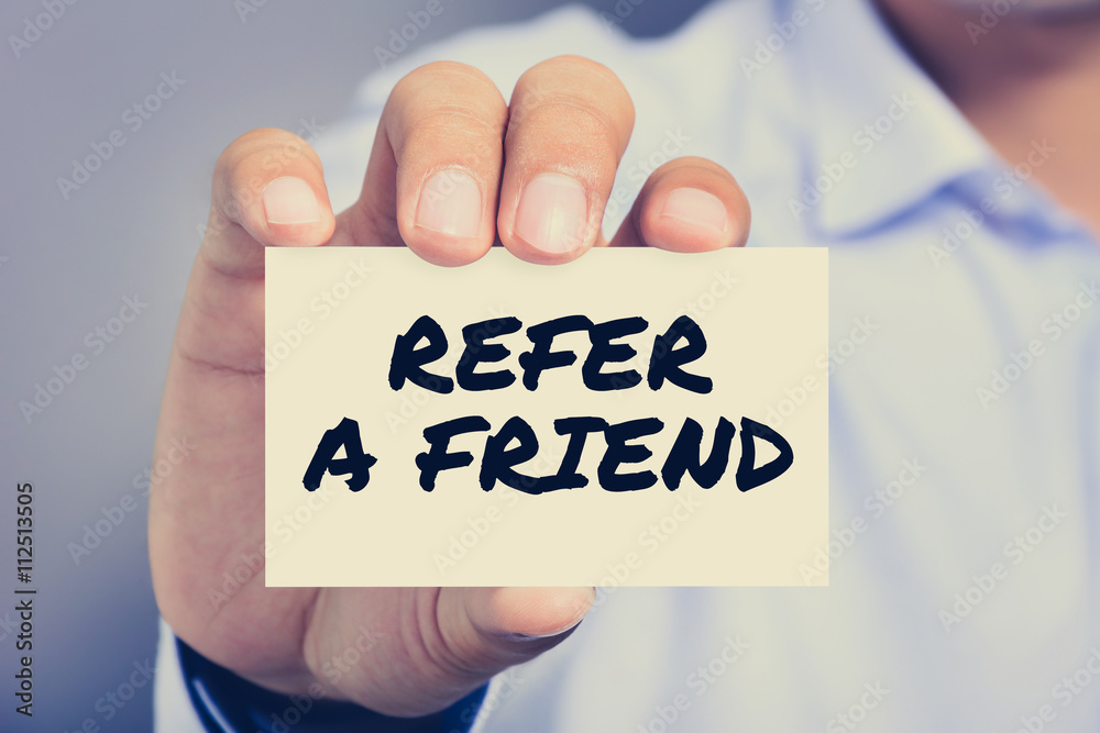 REFER A FRIEND, message on the card shown by a man Stock Photo Adobe